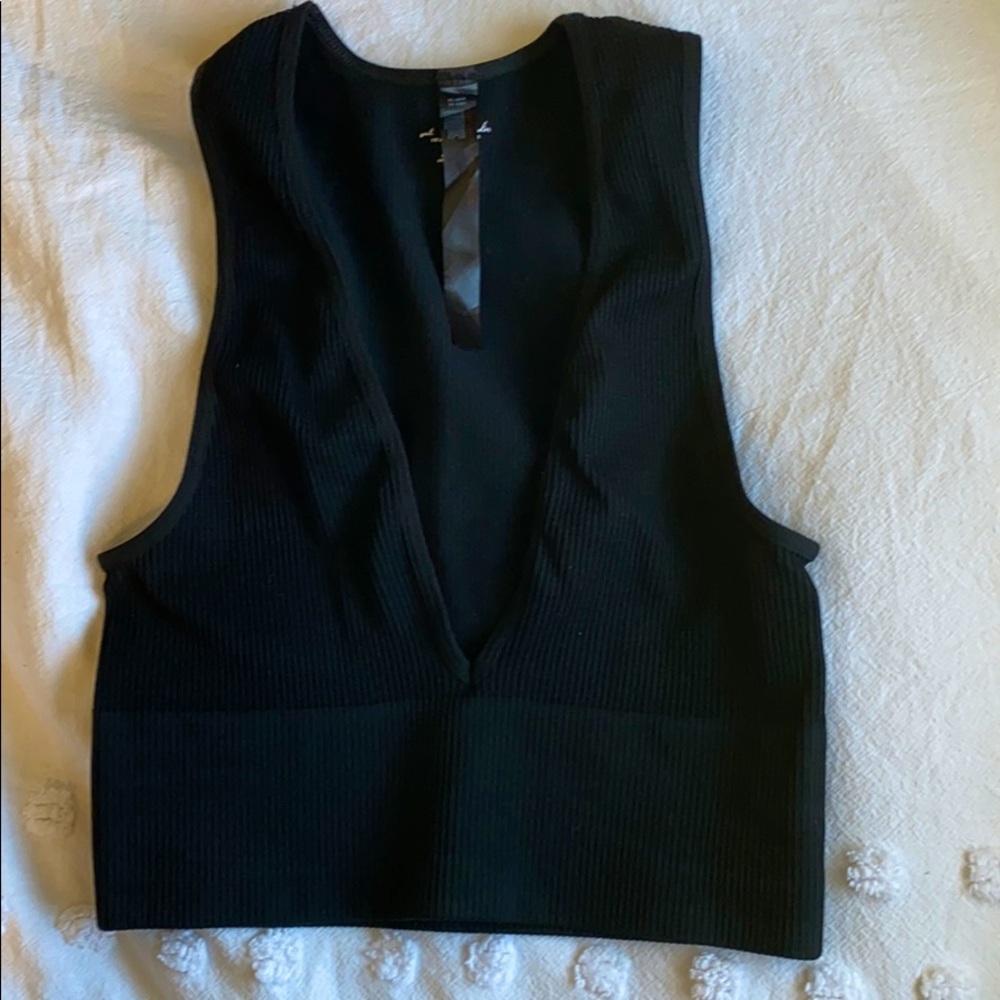 Out from under black crop top
